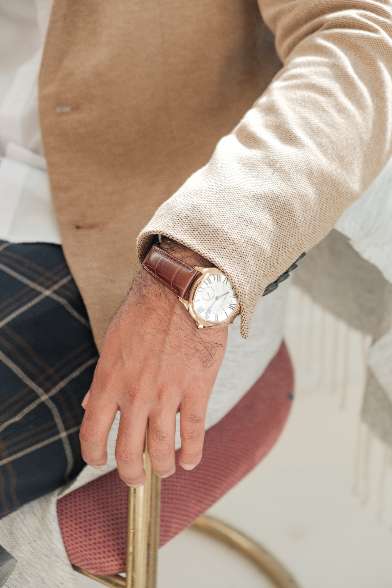 Gentleman wearing a classic rose gold dress watch on a brown leather strap